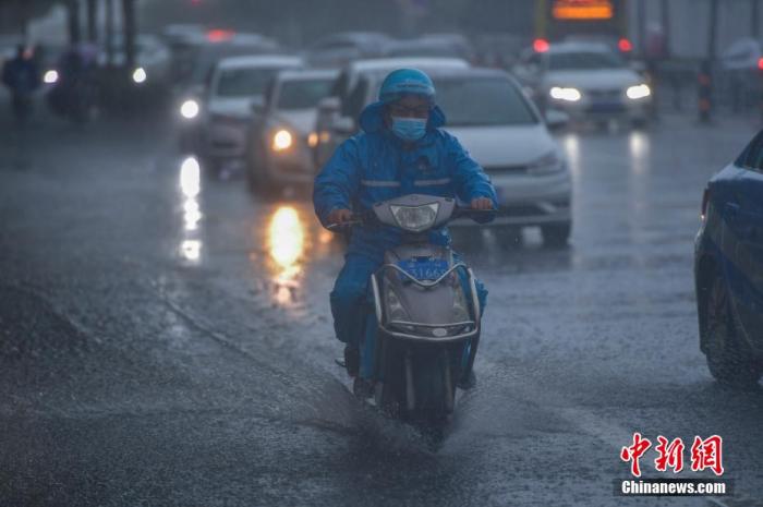 图为外卖小哥在暴雨中骑行。 骆云飞 摄