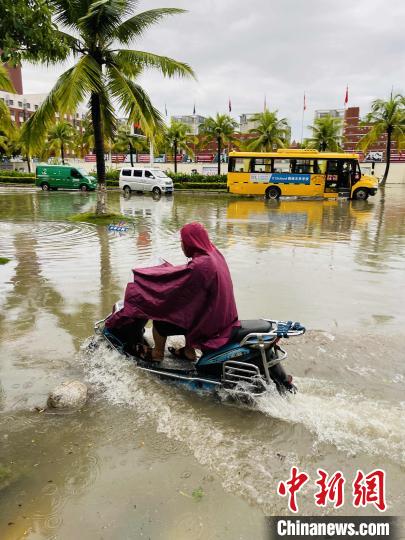 海口多条道路积水，市民艰难出行。　王子谦 摄