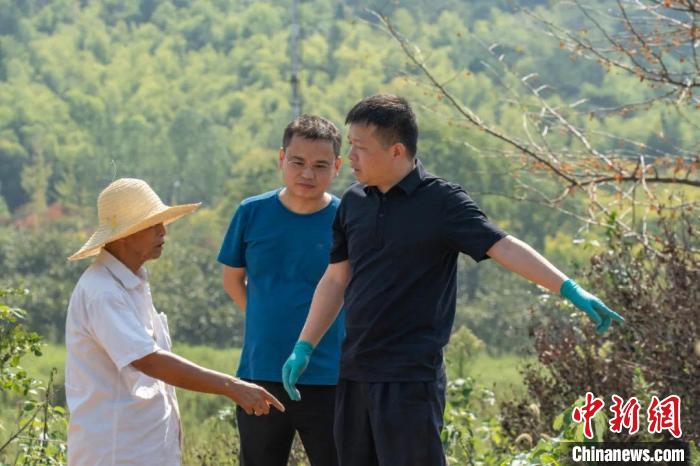 柯伟力向南京当地村民询问墓穴情况。　浙江公安 供图