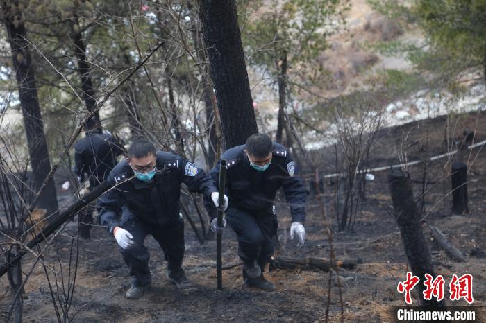 图为移民警察排除火情。　张雨强 摄