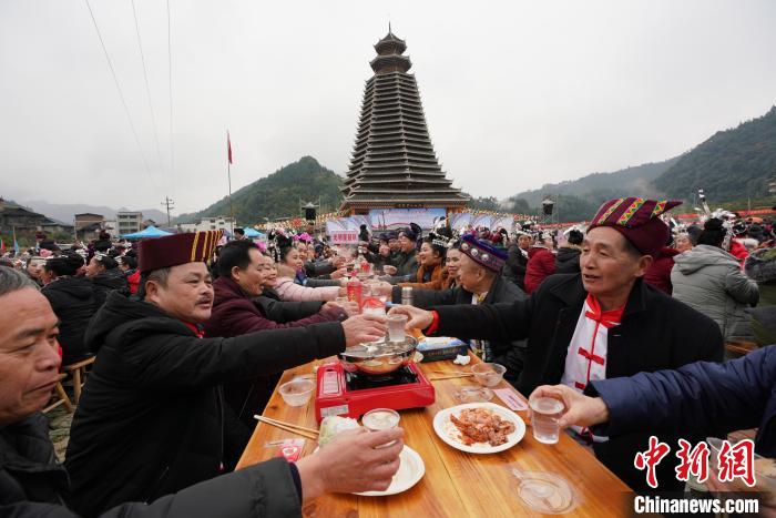 12月15日，在广西龙胜各族自治县乐江镇江口村，侗族群众在鼓楼前摆起“百家宴”欢度侗年。　韦吉阳 摄