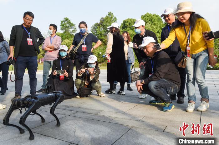 图为参访人员被机器狗所吸引。　何蓬磊 摄