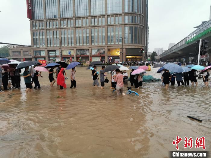 图为郑州民众涉水出行，犹如过河。　韩章云 摄