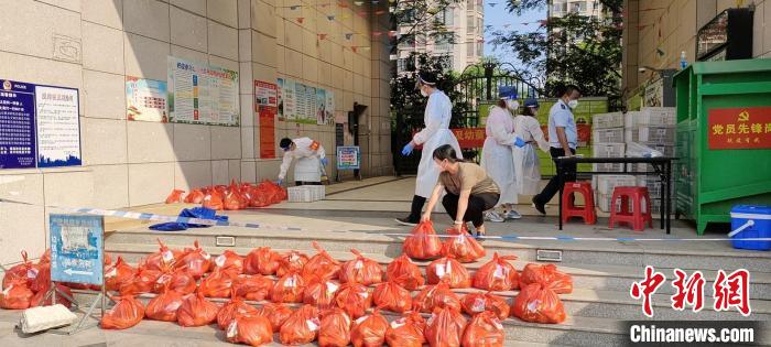 9月30日，七月生鲜超市的黄女士为第七网格点居家隔离的群众送来了150份生活用品。　吴国泉 摄