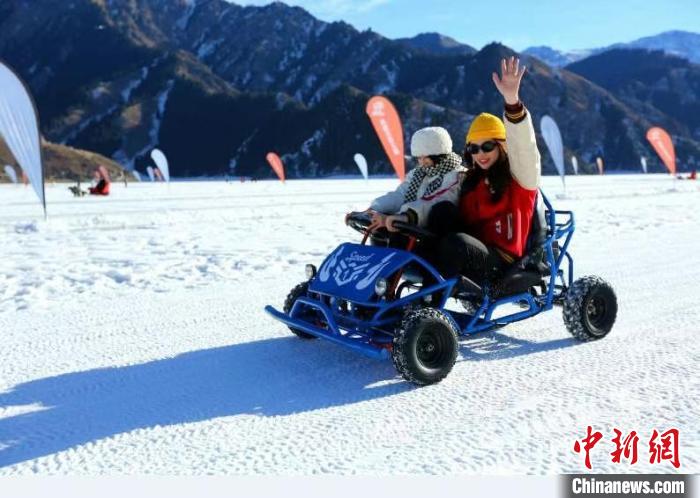 天池湖面雪不厚，阳光普照，雪地摩托让游客玩得不亦乐乎。　刘英 摄