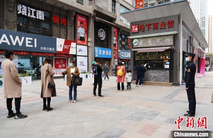 图为西宁市民有序间隔排队领取餐食。　马铭言　摄