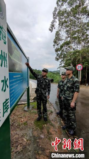 图为武警支队主要负责人到当地水库勘察险情。　孙子斌 摄