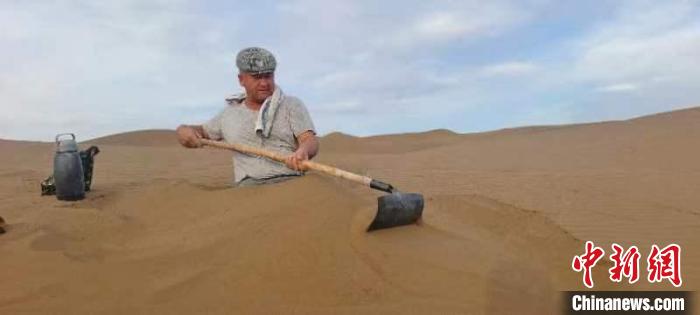 沙疗群众置身于滚烫的沙子中，感受着黄沙带来的“神奇疗效”。　阿不来提·阿不里米提 摄