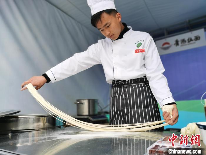 图为拉面师傅拉拉面。 张添福 摄 图为拉面师傅拉拉面。 张添福 摄