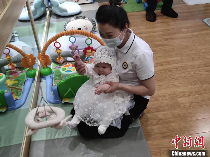 机构保育师在同婴儿玩耍 中新社记者 郝凌宇 摄 机构保育师在同婴儿玩耍 中新社记者 郝凌宇 摄