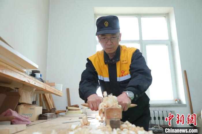图为梁军使用刨子刨平木头表面。 周悦翔 摄 图为梁军使用刨子刨平木头表面。 周悦翔 摄