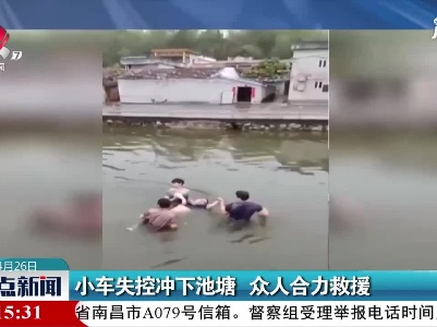 广东：小车失控冲下池塘 众人合力救援