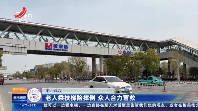 湖北武汉：老人乘扶梯险摔倒 众人合力营救