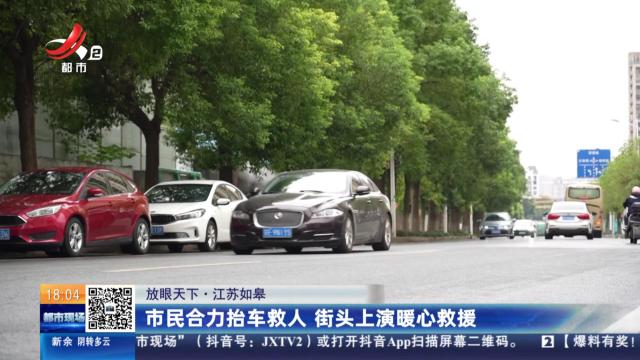 【放眼天下】江苏如皋：市民合力抬车救人 街头上演暖心救援